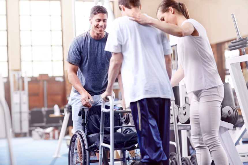 Physical therapists helping man with walker