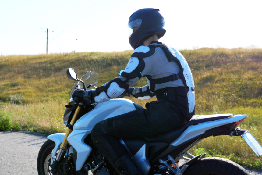 Man in helmet riding fast on powerful sport motorbike at highway.