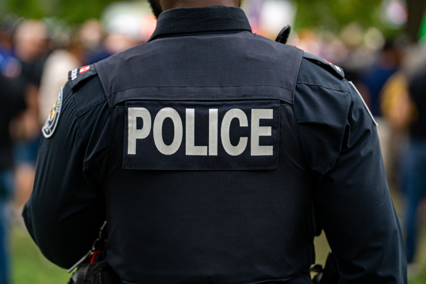Back view of police uniform with label.