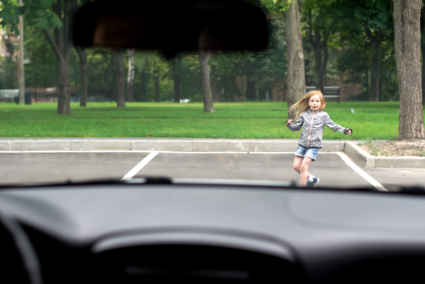 Female kid running front driving car, road traffic safety rules, accident risk