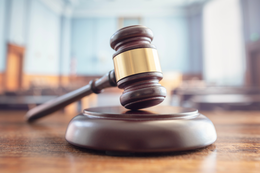 Judges gavel close up in court room legal trial and law background