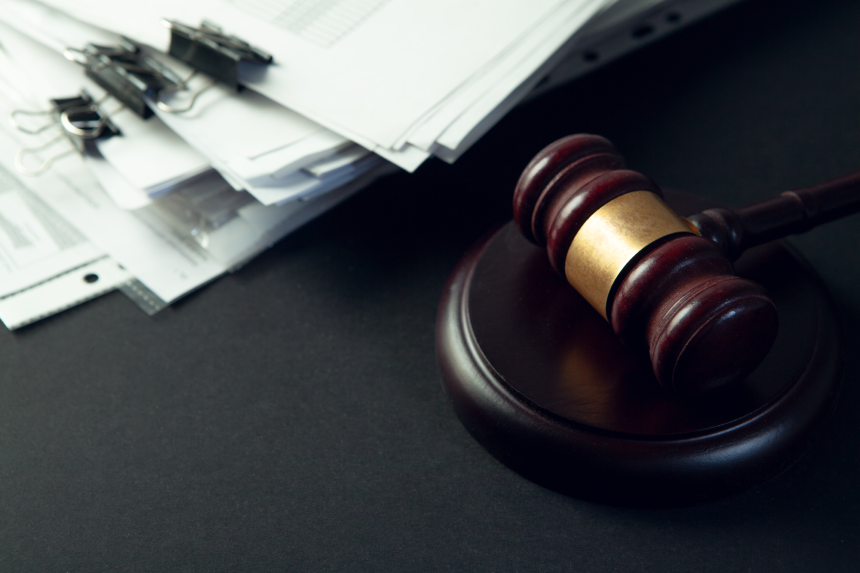 Law theme, mallet of judge, wooden gavel on table
