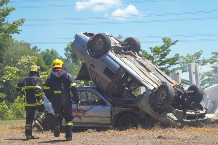 An emergency rescue team helping a victim, saving people life from cars crash accident on side of road.