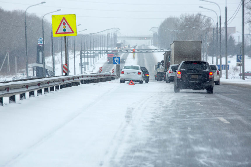 A traffic accident on a country highway. Winter, packed snow, slippery road.
