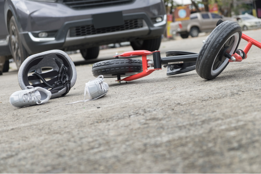 scared and stressed desperate drunken driver and bottle of beer in front of automobile crash car with child bike after traffic accident in city road