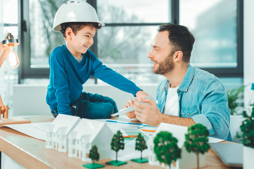 Happy together. Positive delighted family being at work and trying to create housing estate