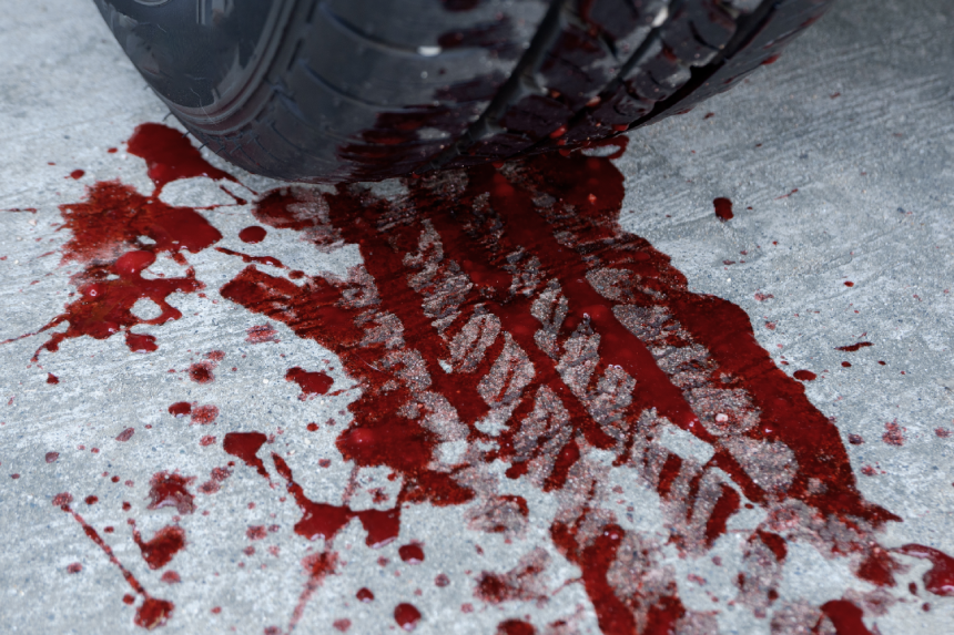 car tire tracks of red blood. concept illustration of a murder, hit and run, or car vehicle accident