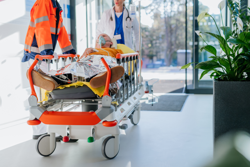 Rescuer bringing patient with serious injury to hospital.