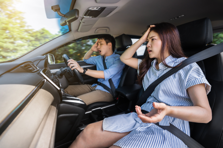 shocked and scared young couple while driving a car