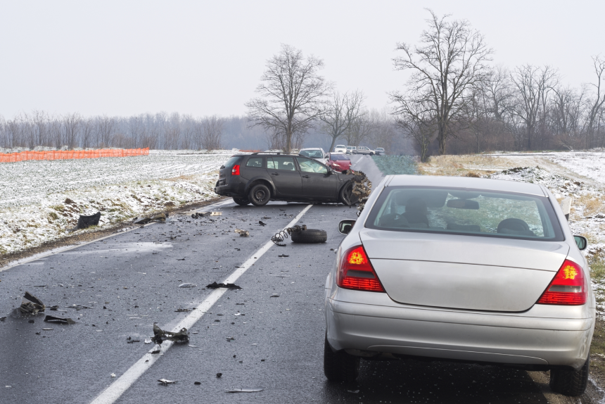 Damaged Cars and Debris on the Wet Road on a Winter Day