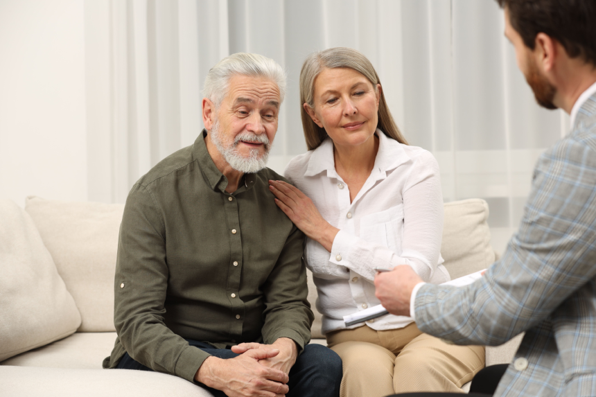 Notary consulting senior couple about Last Will and Testament in office