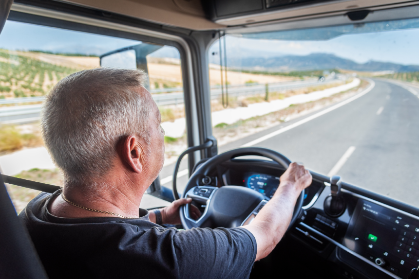 Aging truck driver behind the wheel, experienced but with slower reflexes, highlighting road safety issues
