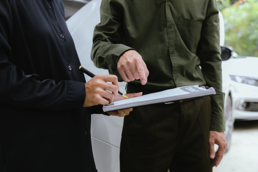 Insurance agent reviews car accident claim