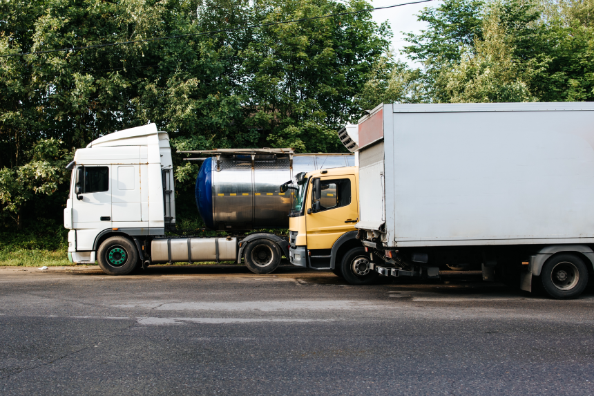 Truck parking. Trucks with white and yellow cabins. Truckers' parking, rest area.