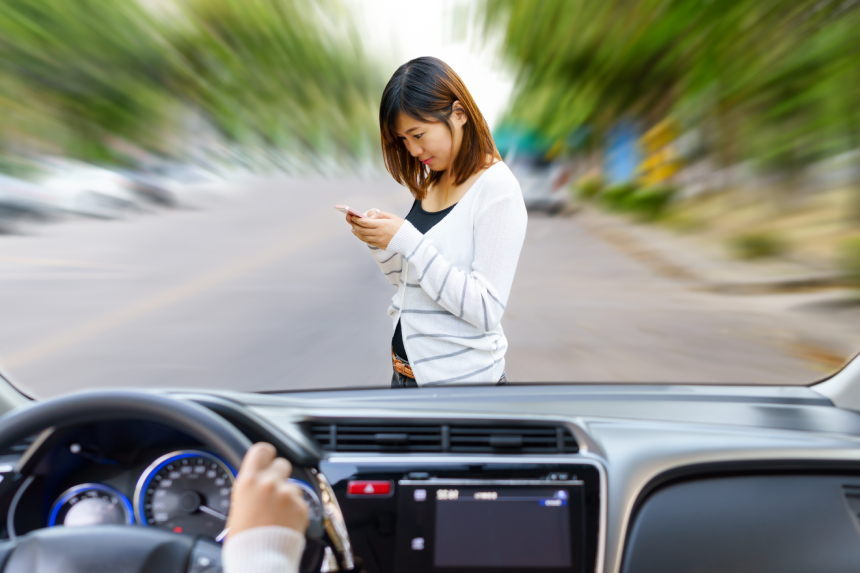 Woman driving fast and dangerous driving. woman using smart phone will be hit by a car on the road