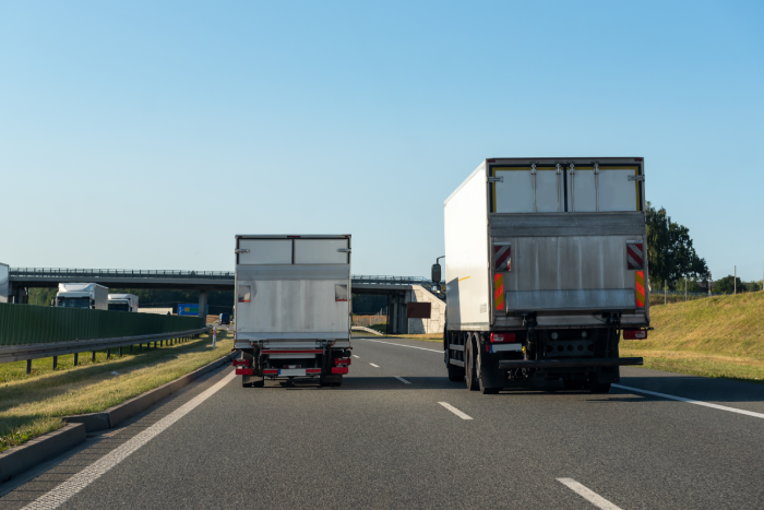 Freight trucks on a highway. Concept of safe driving.